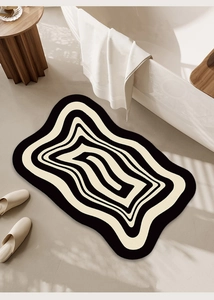 Irregular plush bathroom rug with black and white wave patterns in Nordic style setting