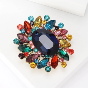 Close-up of rainbow crystal rhinestones on a vintage gold metal brooch setting