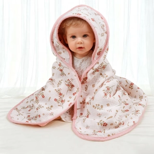 Detail of baby floral cotton hooded towel with soft pink edging and breathable muslin texture