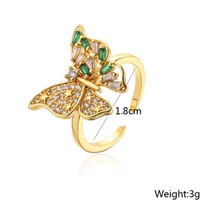 Detail of 18K gold plated butterfly ring showing green zircon inlay and star engravings