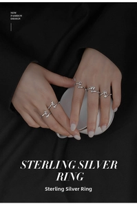 Detail of adjustable S925 sterling silver rings with letter charms and cubic zirconia