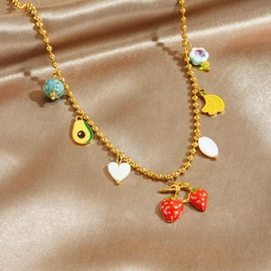Golden bead chain necklace with colorful strawberry and banana enamel charms on satin