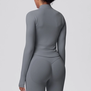Back view showing vertical stripe texture on grey slim-fit yoga jacket and seamless leggings