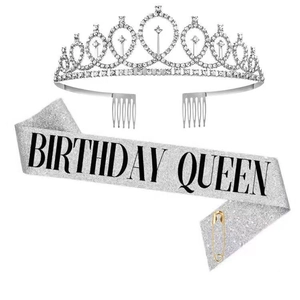 Close-up of sparkling rhinestone birthday crown and silver glitter sash with Birthday Queen text