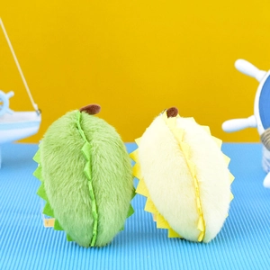 Detail shot of two cute durian plush keychains showing soft texture and vibrant colors