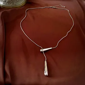 Minimalist silver geometric waterdrop Y-necklace with sleek tapered pendants on silk