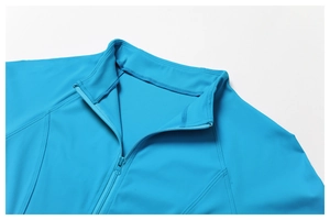 Detail view of high collar and zipper on a blue breathable outdoor sports jacket for women
