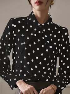Elegant women's black and white polka dot shirt with lapel collar and long lantern sleeves