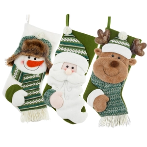 Green knit Christmas stockings with 3D Santa, Snowman and Reindeer holiday hanging decor