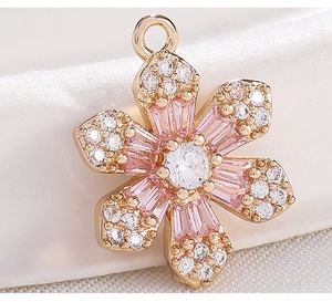 Macro detail of rose gold flower pendant with pink zircon petals and micro-pave crystals