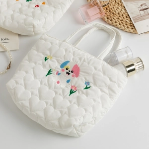 Detailed heart quilting and cute puppy embroidery on a stylish white tote bag