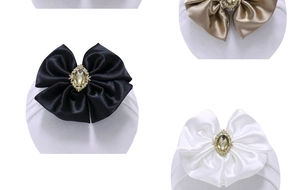 Detailed shot of satin baby headbands with crystal jewelry bow in black and gold