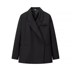 Detail shot of black oversized blazer featuring peak lapels and three front pockets