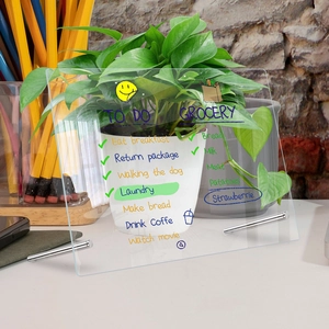Clear acrylic desktop weekly planner with metal stands and handwritten to-do lists