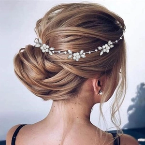 Detail of bridal hair vine with pearls and crystals on an elegant updo wedding hairstyle