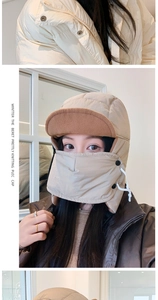 Detail of beige winter bomber hat with earflaps and integrated mask for outdoor wind protection