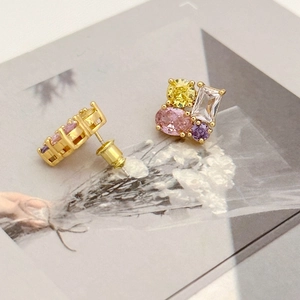 Macro shot of 925 sterling silver studs with colorful zircon stones in a gold finish