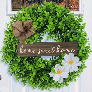 Artificial greenery wreath with home sweet home sign and burlap bow for front door