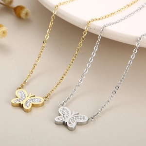 Elegant gold and silver butterfly pendant necklaces with sparkling crystals in a set