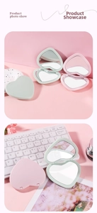 Detail view of heart-shaped folding pocket mirrors in pastel pink and mint green colors