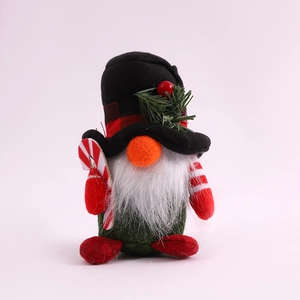 Close-up of Christmas gnome doll with plaid hat, white beard and candy cane prop