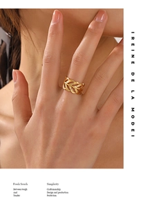Detailed view of fashion leaf ring in gold plating worn by model in minimalist style