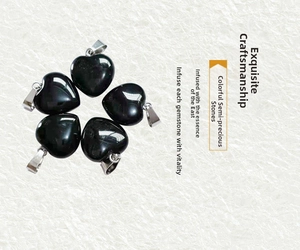 Macro shot of five polished 15mm heart-shaped black semi-precious stone pendants with silver clasps