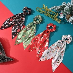 Set of 4 Christmas silk scrunchies with holiday patterns on festive background