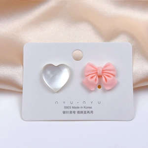 Asymmetric pink bow and white shell heart earrings on S925 silver needle display card
