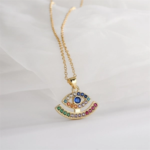 Close-up of heart devil eye pendant necklace with colorful cubic zirconia in gold