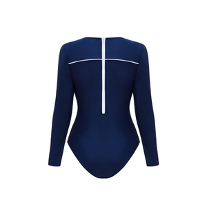 Detail of long sleeve navy swimsuit featuring a white back zipper and cross design