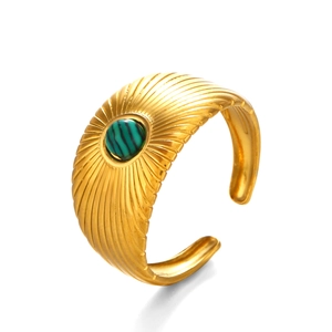 Golden stainless steel open ring featuring a radial texture and a round green malachite stone
