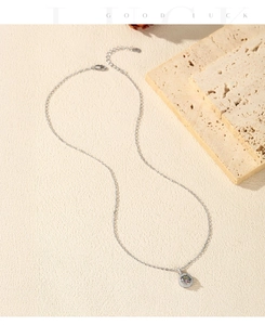 Close-up of S925 silver necklace with 1ct colorful moissanite pendant on stone decor
