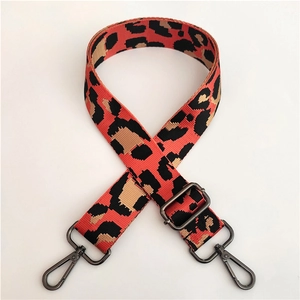 Detail of adjustable leopard print wide shoulder strap with dark grey metal hooks