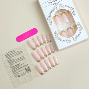 Pink French press-on nail kit with gold glitter gradient, adhesive tabs, and nail file