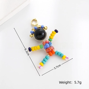 Detailed view of handmade colorful bead cartoon figure pendant with golden lobster clasp