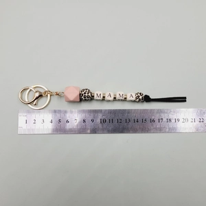 Detail of MAMA beaded keychain showing 20.5cm length measurement and soft black tassel