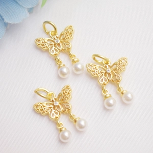 Detail of 14K gold plated hollow butterfly pendant with zircon and double pearls