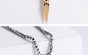 Detail of 18K gold-plated spike pendant on a silver box chain for men's streetwear