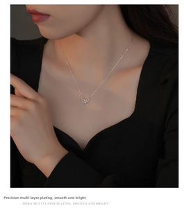 Detail of s925 silver butterfly necklace with colorful stones on model neck
