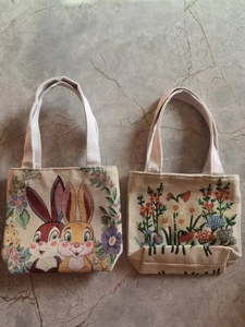 Macro detail of beige canvas tote bags with exquisite double-sided floral embroidery