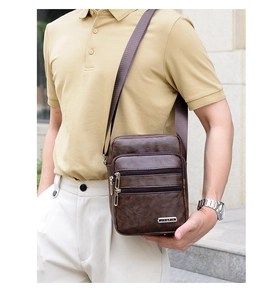 Detail of dark brown PU leather crossbody bag with multiple zippered pockets and metal logo
