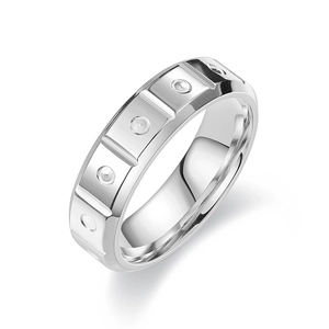 Polished titanium steel geometric ring with segmented block pattern on white background