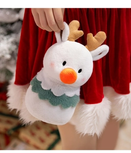 Close-up of cute plush reindeer toy with white fur and festive green collar detail