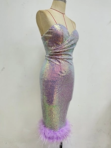 Detailed view of luxury sequin fabric and purple ostrich feather trim on a cocktail dress
