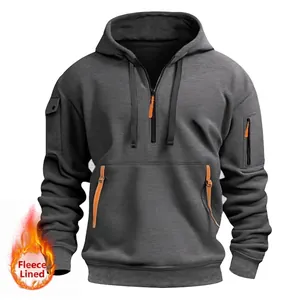 Detail of fleece lined hoodie featuring orange zip accents and sleeve pocket design