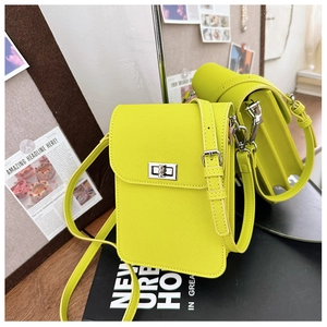 Detail of lime green mini crossbody phone bag with crossgrain texture and silver lock