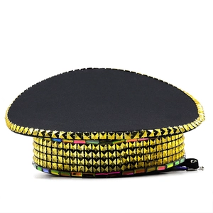 Detail of black captain hat featuring golden pyramid studs and colorful mirror rhinestones