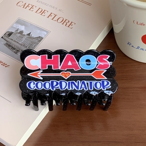 Elegant black acrylic claw clip with colorful Chaos Coordinator text and red heart