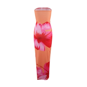 Detail of orange floral strapless maxi dress featuring vibrant pink hibiscus prints